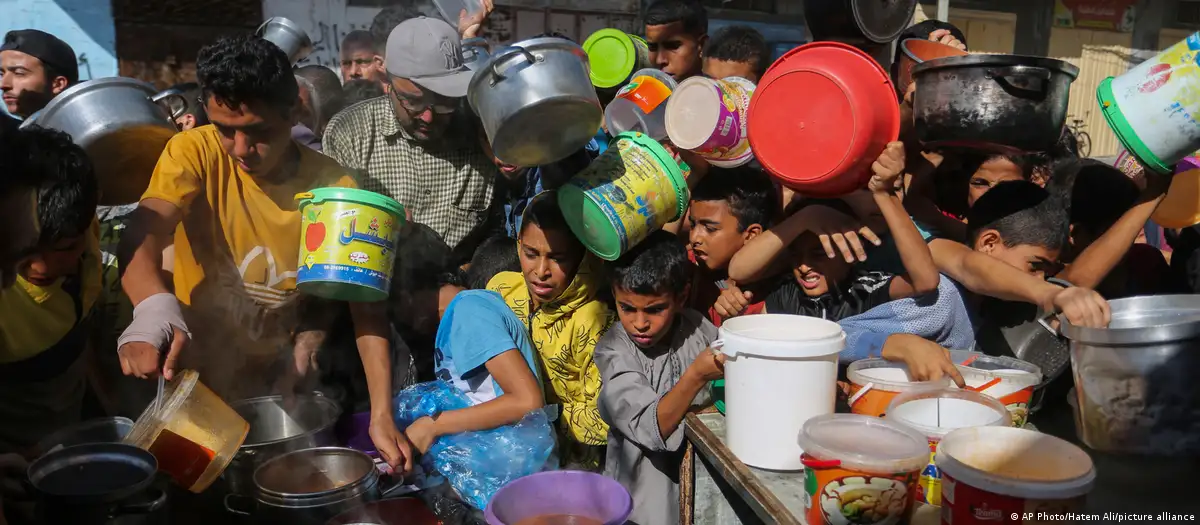 Children crowd around a food bank near Rafah in the southern Gaza Strip