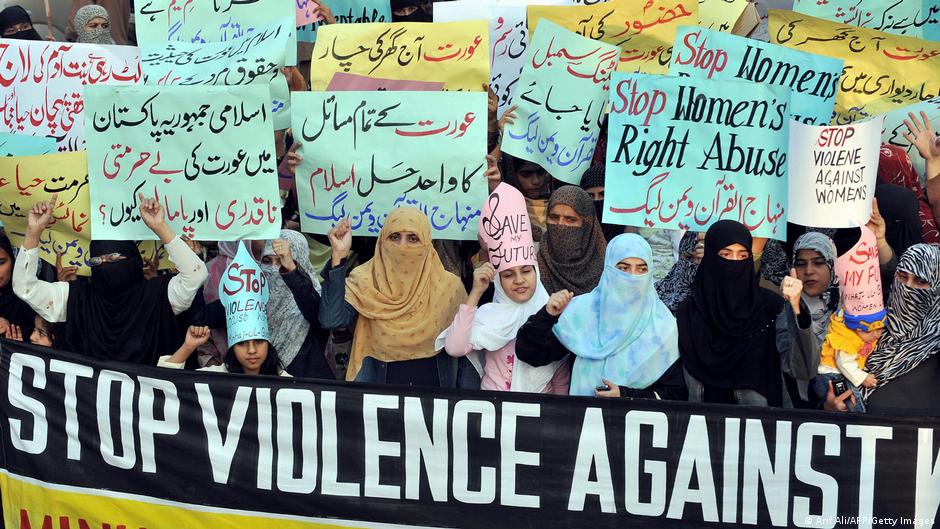 Pakistani women wave placards at a women's rights demonstration in Lahore