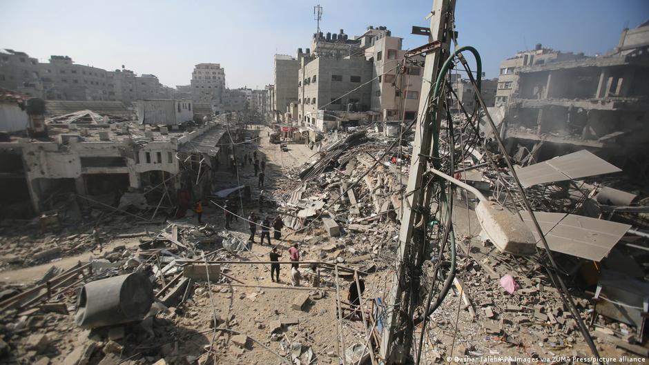 People search through buildings, destroyed during Israeli air raids on the Shati refugee camp in Gaza City