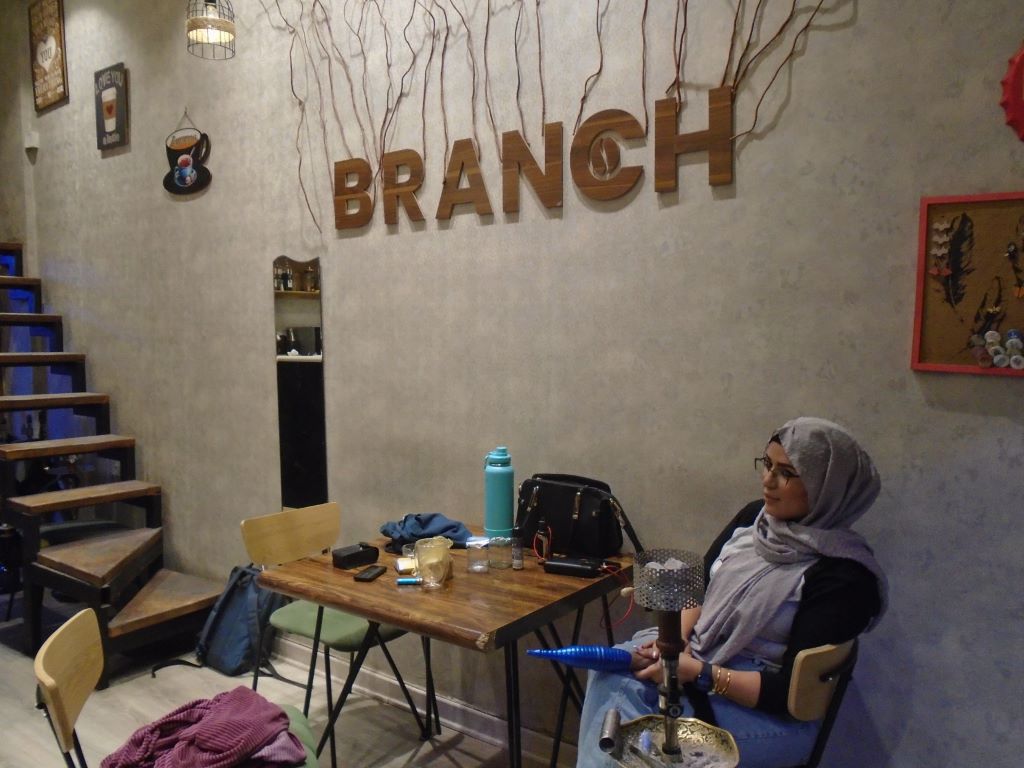 Rawan al Zaidi sits at a table in Cafe Branch in Baghdad