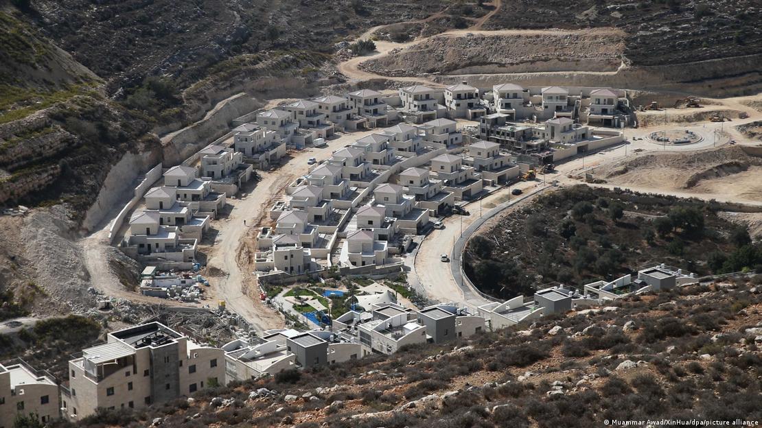 A newly constructed Israeli settlement – rows upon rows of neat white houses – in the Palestinian West Bank