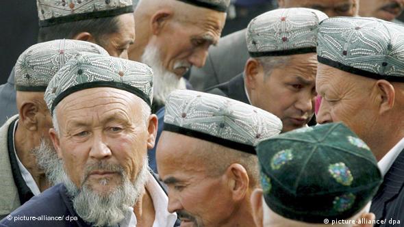 Uighur men exit the Idkah Mosque after prayers in Kashgar during the ongoing holy month of Ramadan, China's Xinjiang Uyghur Autonomous Region, 13 October 2006