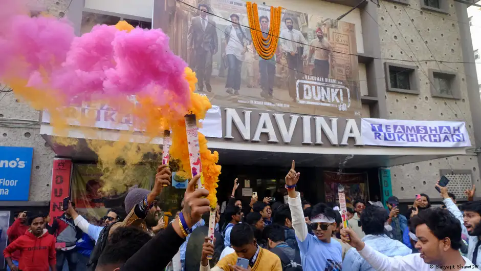 Fans of Muslim Bollywood star Shah Rukh Khan gather outside a cinema showing his latest blockbuster film "Dunki"