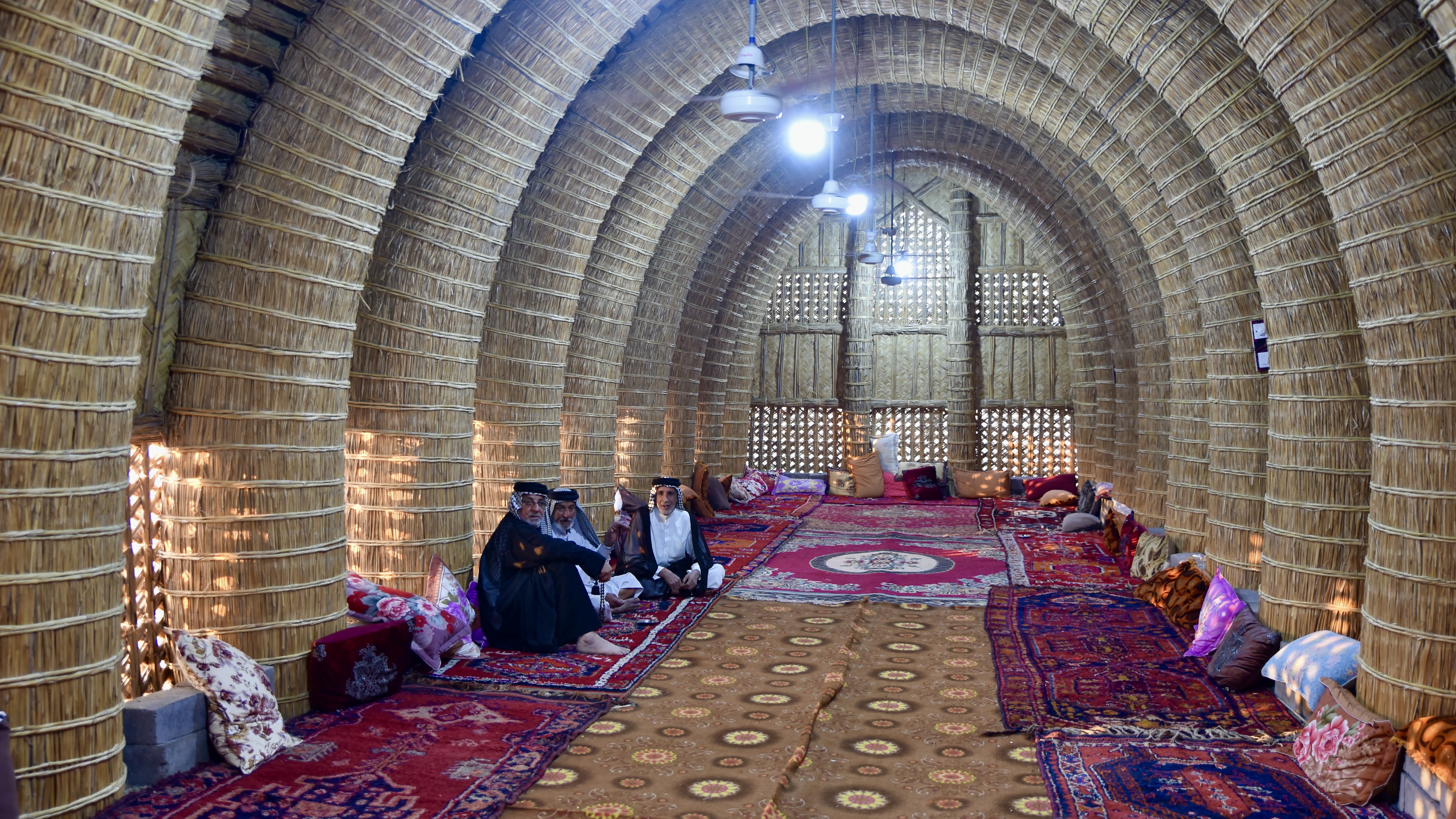 Interior of a traditional mudhif, constructed using reeds. Lined with carpets, the hall provides a meeting place for male members of the community