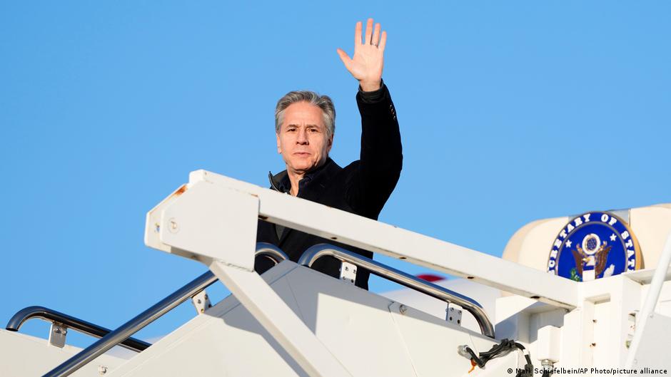 Secretary of State Antony Blinken waves as he boards a plane at Joint Base Andrews, Md., en route to Saudi Arabia as part of his fifth urgent trip to the Middle East