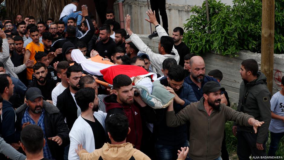 Mourners carry the body of Palestinian Jihad Abu Alia during the funeral procession following clashes the previous night in the West Bank village of Al-Mughayyir, near Ramallah, 13 April 2024