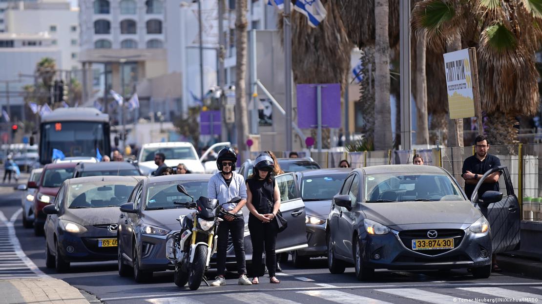 People stand in silence beside their vehicles on a street in Israel on Holocaust Martyrs' and Heroes' Remembrance Day
