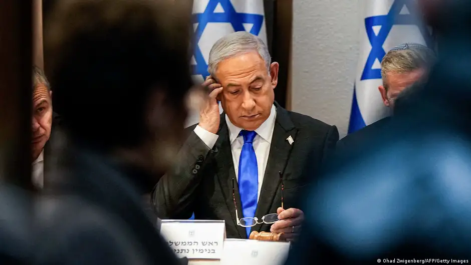 Israel's Prime Minister Benjamin Netanyahu holds his glasses and looks down as he chairs a cabinet meeting at the Kirya military base, which houses the Israeli Ministry of Defence, in Tel Aviv on 24 December 2023