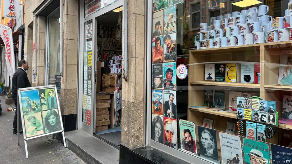  The storefront where a bomb exploded 20 years ago, the shop window filled with portraits of people