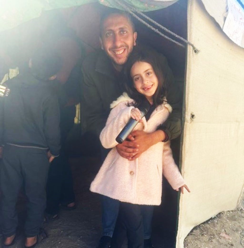 Mohamed Isbitah with his daughter Rana in Rafah. She wants to become a journalist one day