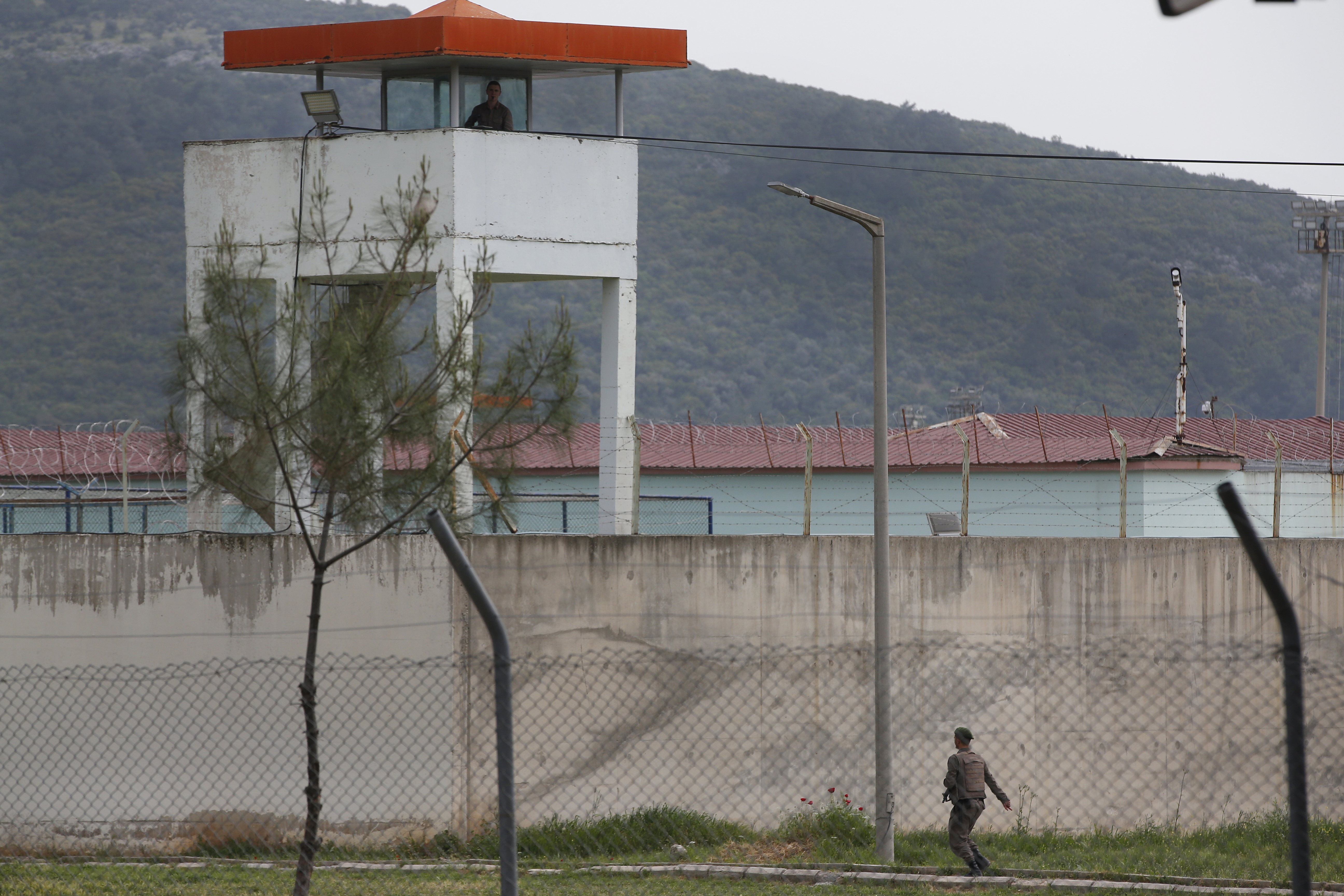 Exterior view of a prison in Turkey. A guard is on patrol.