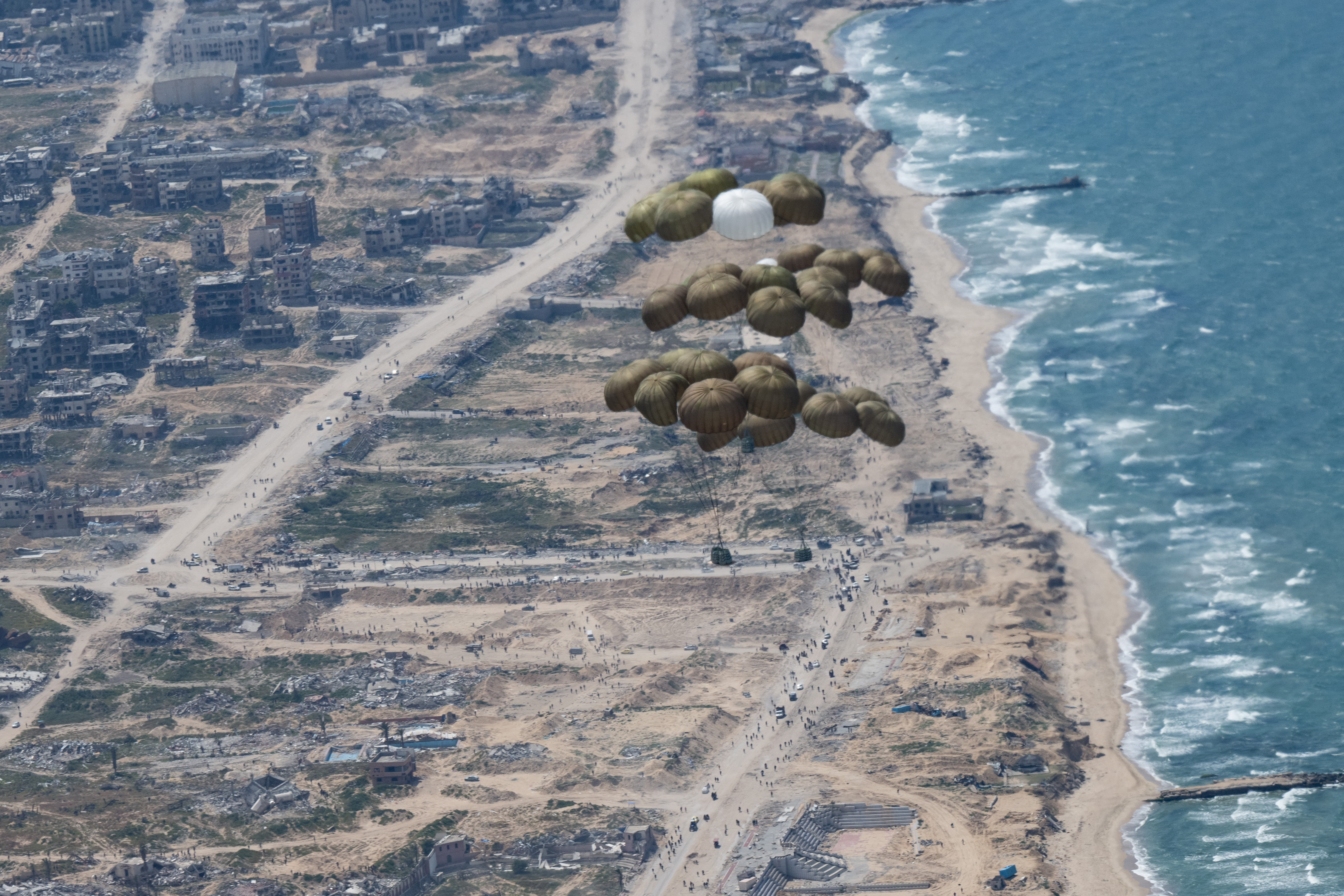 Parachutes with relief supplies float over the Gaza Strip