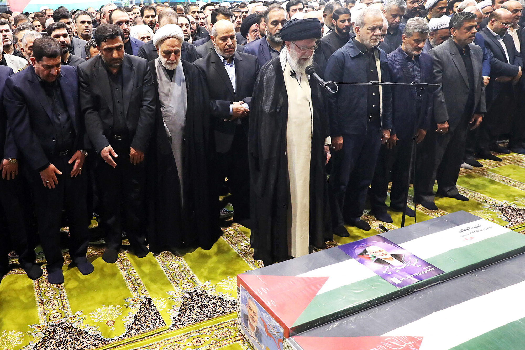 Ayatollah Ali Khamenei says the prayer over the coffin of the late Hamas leader Ismail Haniyeh and his bodyguard during the funeral procession in Tehran before he is buried in Qatar.