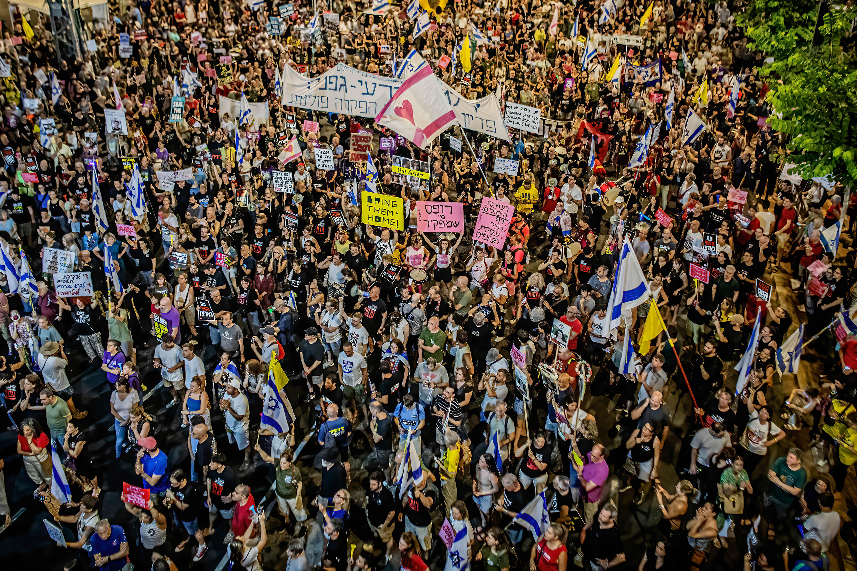 Israelis hold placards during a rally. The families of the Israeli hostages held by Hamas in the Gaza Strip demand an agreement on the release of the hostages and an end to the war.