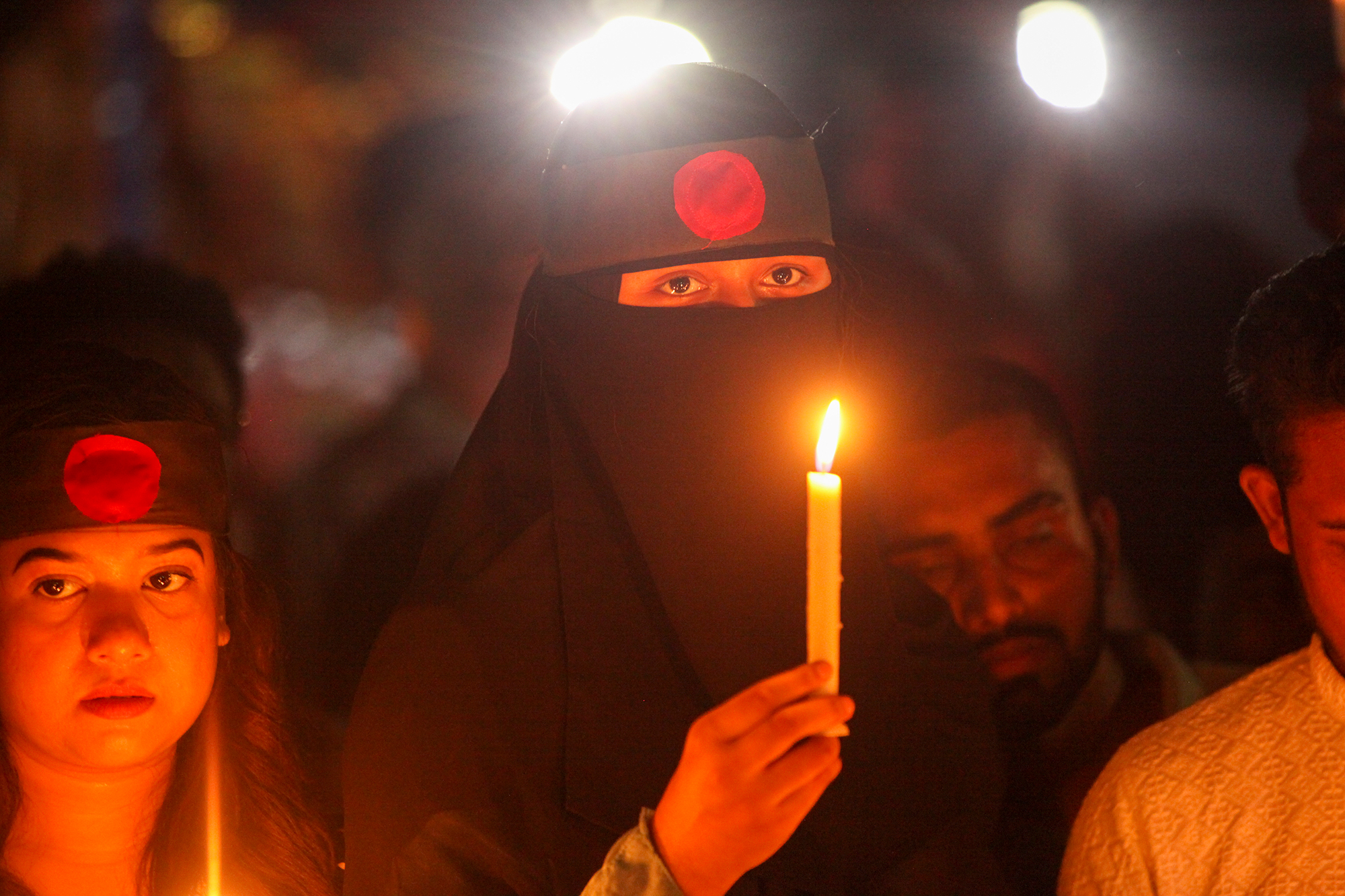 Students with candles for fellow students killed during the protests in Bangladesh.