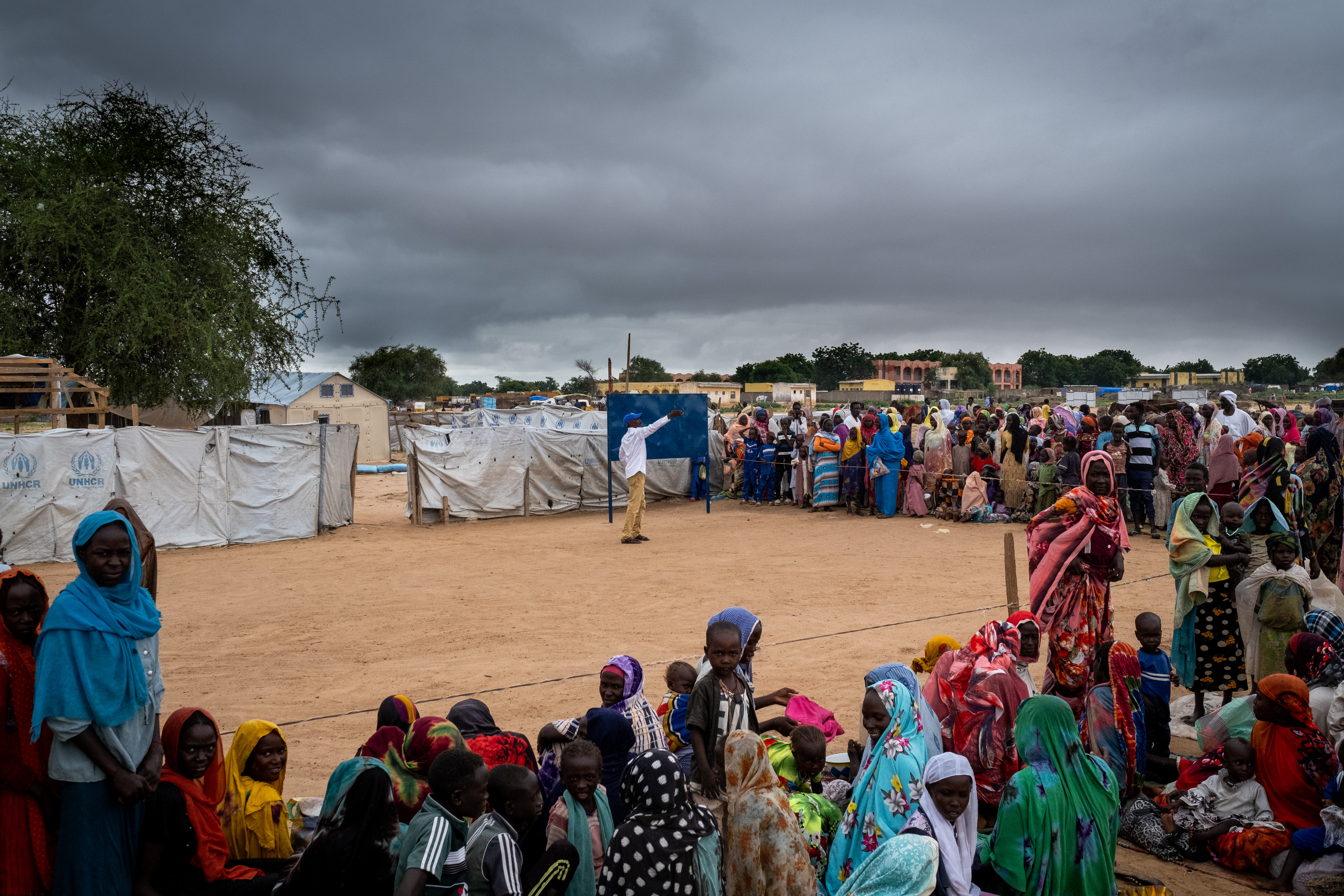 Officially only a transit point, over 250,000 people have settled in the Adré camp. Recent arrivals stand outside the UNHCR registration tent, having crossed the border overnight.