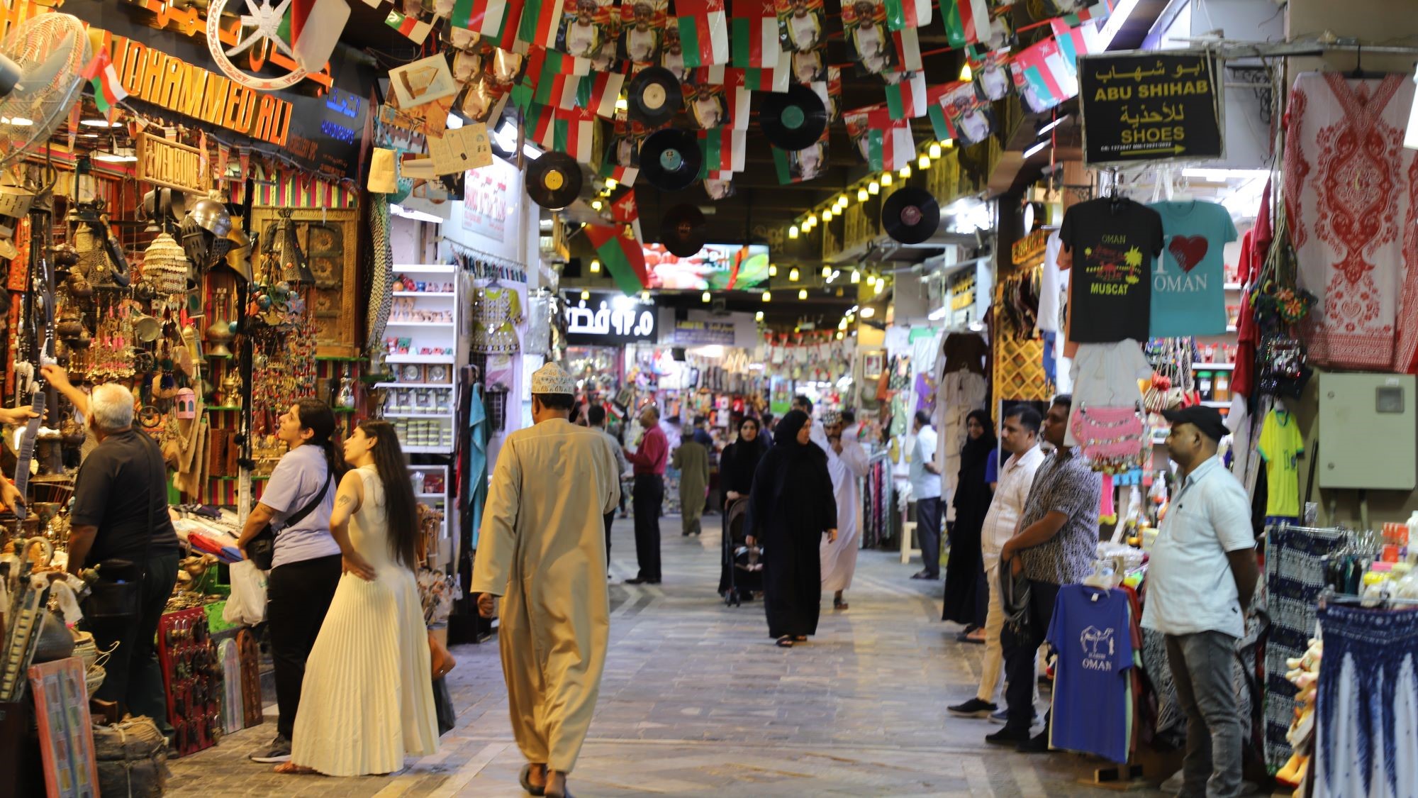 People walking through an indoor market.