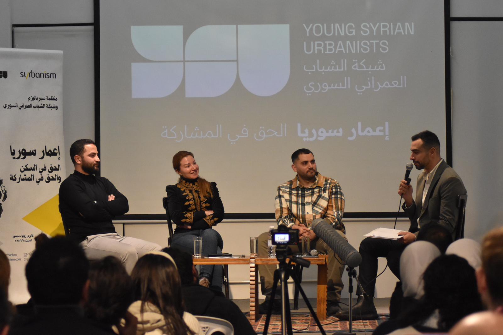 Young Syrian urbanists sitting on the stage and discussing right for participation