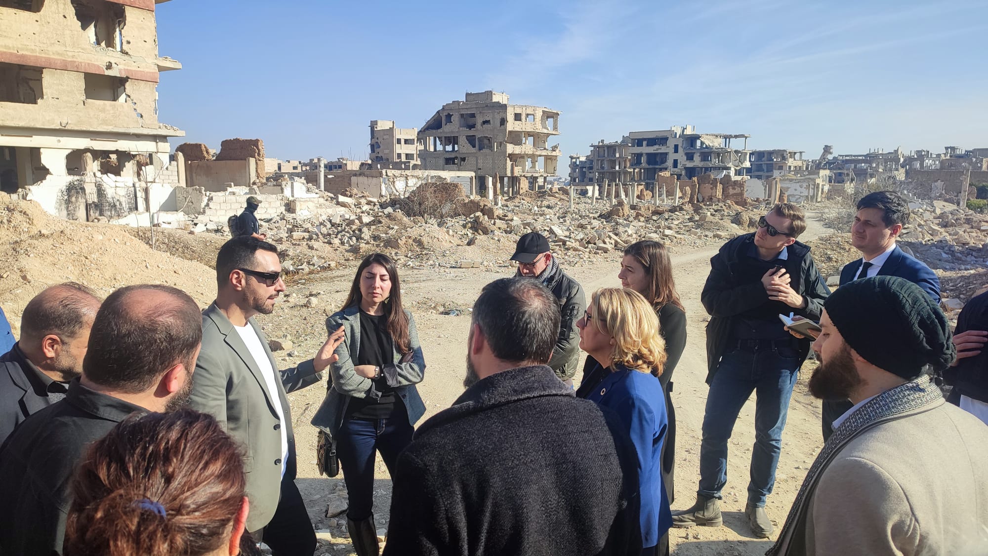 Architects meeting among ruins to talk about reconstruction