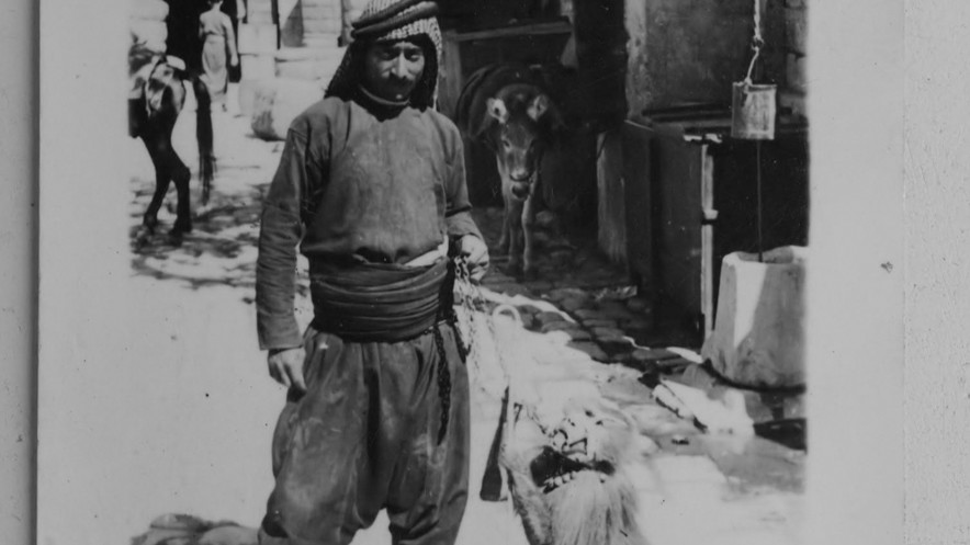 Ein Mann posiert mit dressiertem Affen (schwarz-weiß Bild)