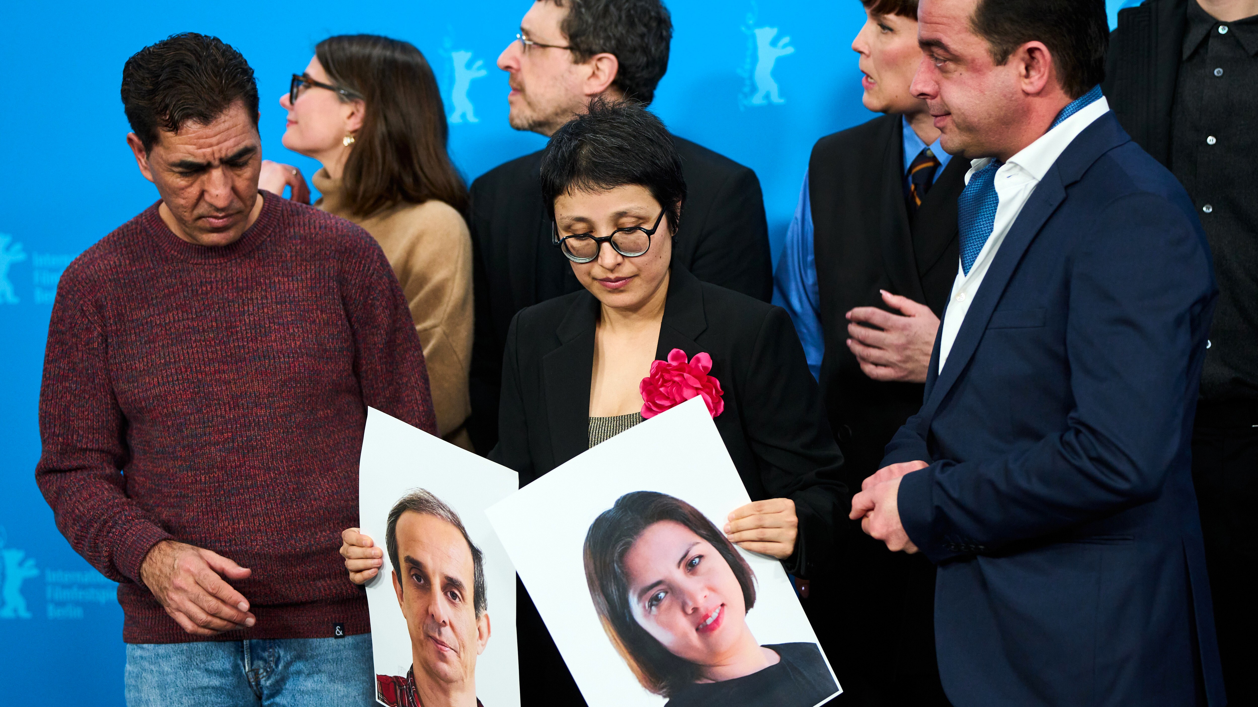 Director Shahrbanoo Sadat, centre with flower, poses with the cast and crew for photographers at the photo call for the film 'No Good Men' during the International Film Festival, Berlinale, in Berlin, Thursday, Feb. 12, 2026.