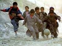 Afghan children play soccer in a dried-out riverbed in downtown Kabul (photo: AP)