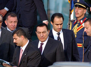 Egyptian President Hosni Mubarak, center, and his son Gamal, background right, leaves the conference center at the Red sea resort city of Sharm el-Sheik, Egypt, 8 February 2005 (photo: AP)