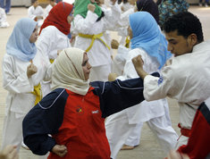 Headscarfed women during judo exercise (photo: AP)