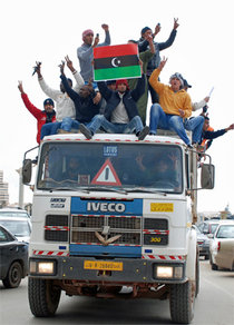 Insurgents are celebrating their victory in Benghazi by driving through town on the top of a truc