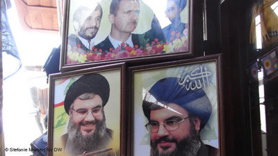 A photo montage showing Bashar al-Assad flanked by Hassan Nasrallah and Mahmoud Ahmadinejad on sale at a market (photo: Stefanie Markert/DW)