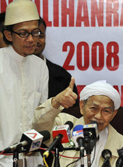 Nik Aziz, chief minister of Kelantan, right, during a press conference (photo: AP)