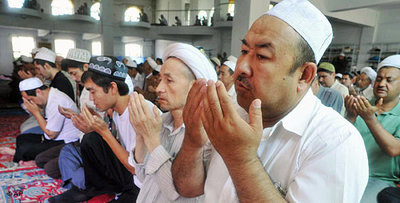 Uighur men in at protest prayer in Urumqi (photo: AP)