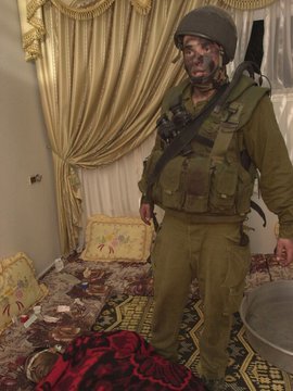 An Israeli soldier on duty in a Palestinian home (photo © Breaking the Silence)