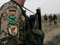 German soldiers, part of the International Security Assistance force (ISAF) stand guard during the opening ceremony of a German-funded medical center project in the Deh Sabz district of Kabul, February 2007 (photo: AP)