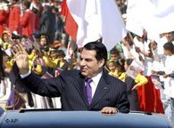 Tunisian President Zine El Abidine Ben Ali waves from his car as he arrives at the Rades stadium, south of Tunis, 20 March 2006 (photo: AP)