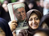 Iranian woman holds up a magazine, displaying the image of Akbar Hashemi Rafsanjani (photo: AP)