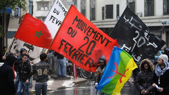Anti-government protesters hold the Moroccan national flag and the 20th February movement flag during a rally organized by the 20th February movement in Casablanca in November 2011 (photo: AP)
