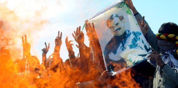 Supporters of the pro-Kurdish Peace and Democracy Party hold a picture of jailed Kurdistan Workers' Party (PKK) leader Abdullah Ocalan as they celebrate the Newroz, the new year, in Istanbul on March 21, 2010