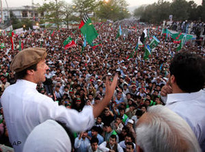 Pakistani cricket legend-turned politician Imran Khan, center wearing cap, addresses the crowd during a rally against the U.S. drone strikes in Pakistani tribal areas, Saturday, 23 April 2011, in Peshawar, Pakistan (photo: AP)