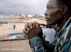A Senegalese refugee after his return at the beach in Dakar (photo: dpa)