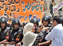 An Egyptian woman argues with anti-riot soldiers as she tries to make her way past the court where Egypt's leading opposition candidate for president, Ayman Nour, is on trial, 28 June 2005, in Cairo (photo: AP)