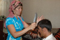 Ferusa Tadschiwa, a traditional Uzbek healer and, Otabek, one of her patients (photo: Jesko Schmoller)