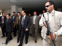 Iraqi Prime Minister Nouri al-Maliki and his entourage of bodyguards during a visit at the University in Baghdad (photo: AP)