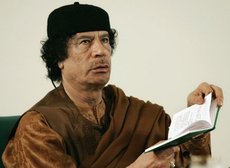 Muammar al-Gaddafi with the 'Green Book' (photo: AP)
