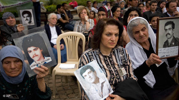 Lebanese women hold pictures of their relatives disappeared in the war (photo: AP)