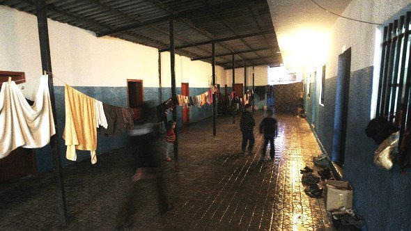 Syrian children who fled with their families, the violence in Baba Amr neighbourhood, in the flashpoint city of Homs, wander around in the corridor of a school converted to a refugee center in the area of Wadi Khaled on the Lebanese-Syrian border northern Lebanon on March 15, 2012 (photo: Joseph EidAFP/Getty Images)