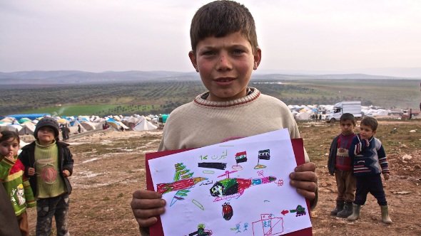 A Syrian boy, Abdullah, 9, from Hama depicts a helicopter dropping a barrel bomb of TNT on his home, a popular weapon in the regimes arsenal. Atmeh refugee camp, Syria, 18 January 2013 (photo: Andreas Stahl/DW)