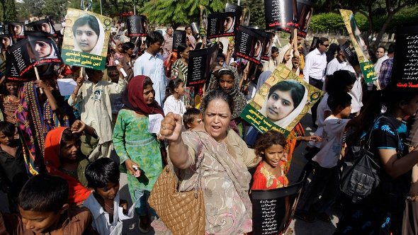 Pakistani students and teachers hold posters of 15-year-old Malala Yousufzai while they take part in a demonstration in Karachi, Pakistan on Saturday, Nov. 10, 2012 (photo: AP)