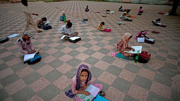 تلميذات باكستانيات يتلقين التعليم في إحدى الحدائق العامة. أ ب