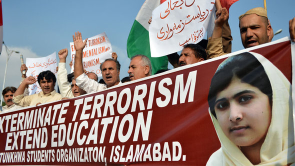 Men show their solidarity with Malala Yousafzai at a demonstration (photo: Aamir Qureshi/AFP/Getty Images)
